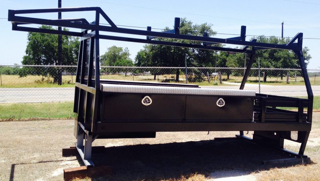 Custom flatbed body with headache rack and underbody toolboxes built by Ace Welding