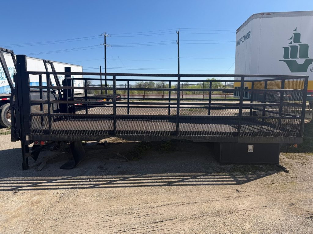 Ace Welding technician-repaired liftgate on a stake body flatbed truck