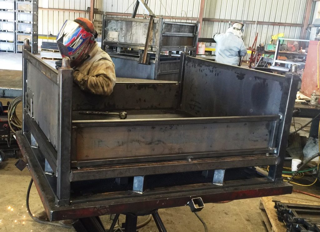 Ace Welding fabricator welding a dump body in the San Antonio shop